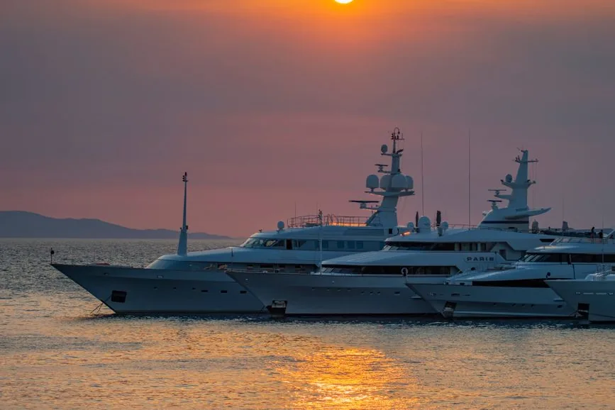 Yachts moored at sunset