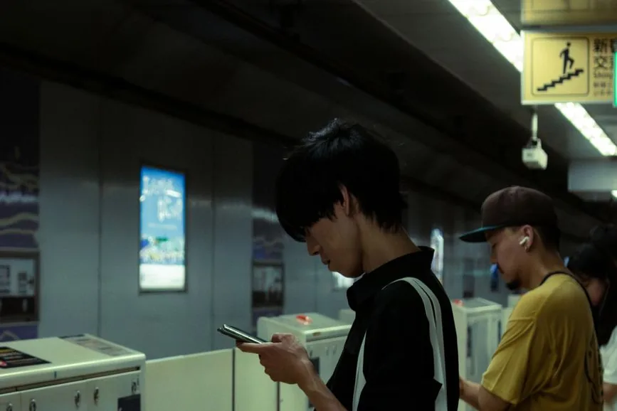 Commuters at a Tokyo station ticket gate